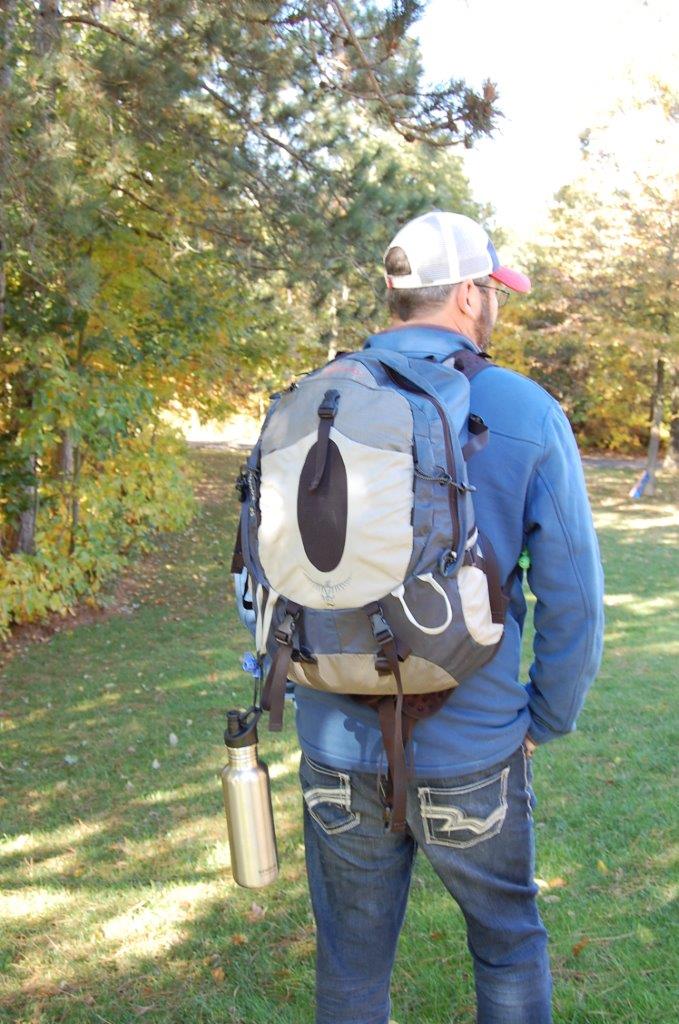 Water bottle lashed to backpack